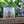 Potager Soap Co. bar of soap with a label on a wooden surface with blurred greenery and flowers in the background