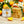 Potager Soap Co. Orange Dreamsicle soap bars with packaging on a wooden surface with oranges and ylang ylang flowers